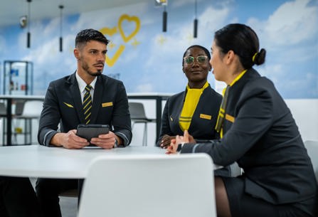 Members of Vueling cabin crew seated round a table