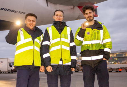 British Airways engineering apprentices pose in front of plane