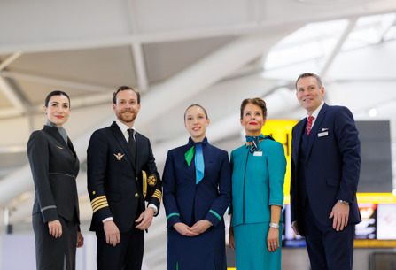 Cabin crew members and Iberia pilot posing at Heathrow T5