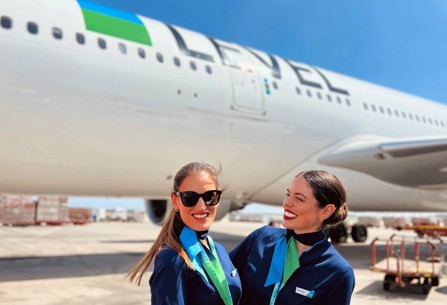 Level female cabin crew members reacting in front of plane