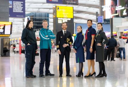 IAG staff posing at Heathrow departures concourse