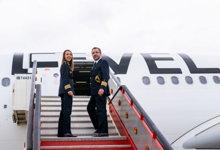 LEVEL cabin crew posing at plane exit