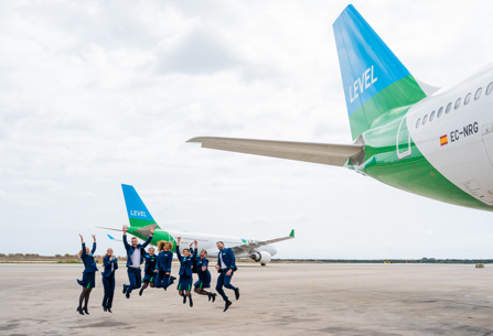 LEVEL cabin crew posing by plane