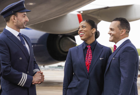 Members of British Airways cabin crew talking to pilot