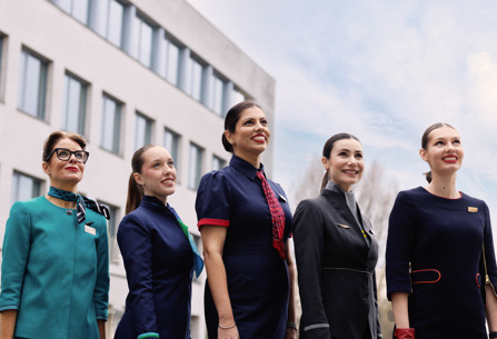 Members of IAG airlines cabin crew posing out headquarters building