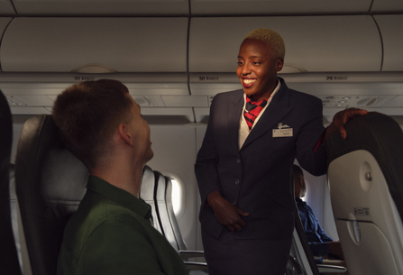 Member of British Airways cabin crew talking to customer